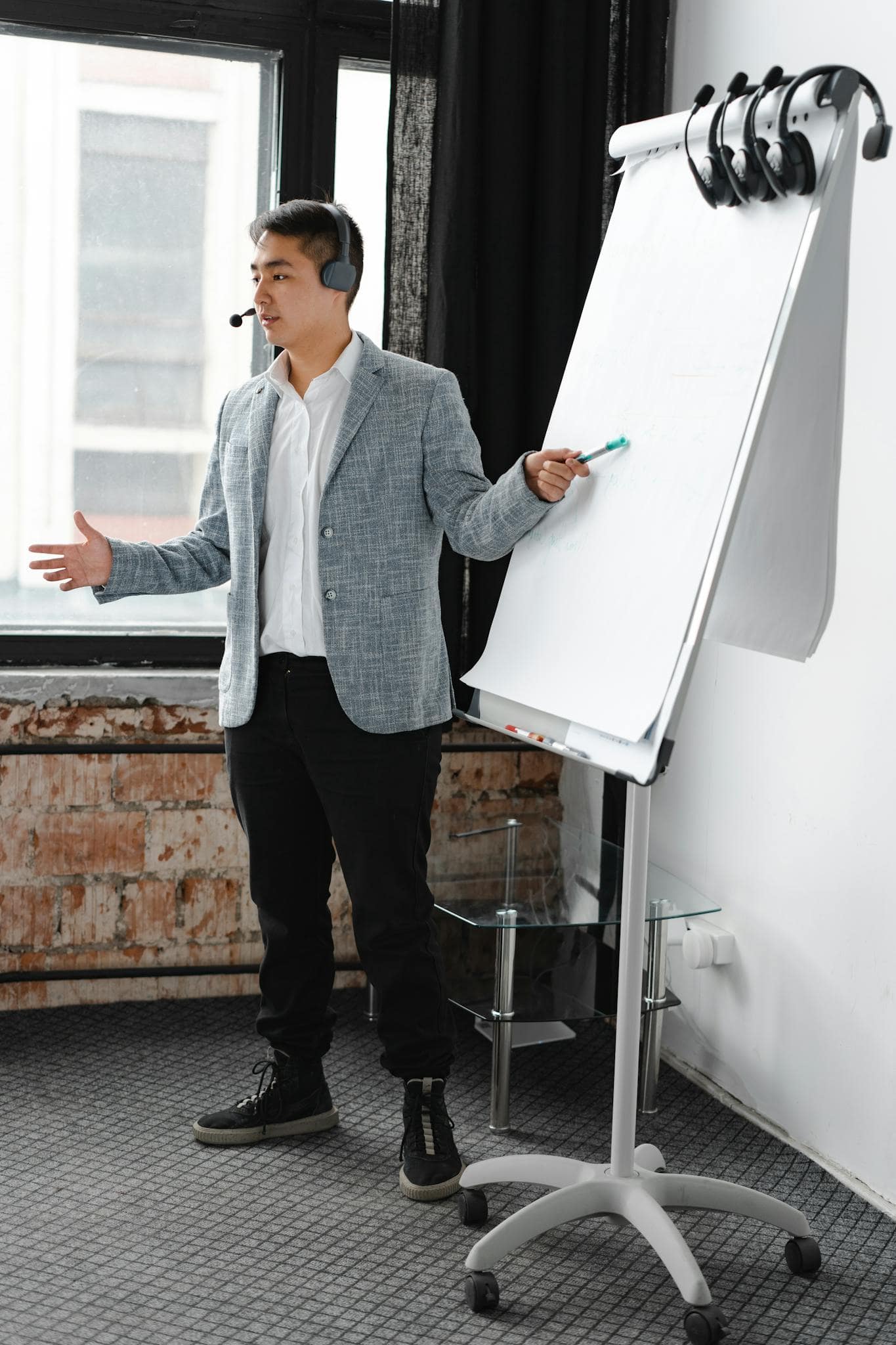 Engaging business presentation by a call center agent using a flip chart, indoors.